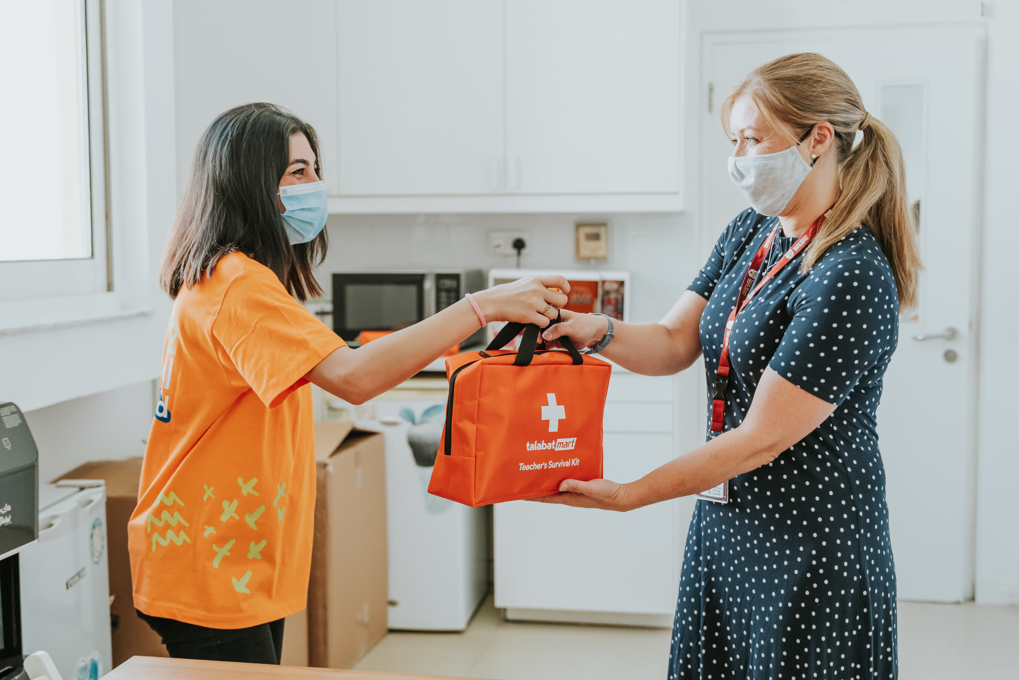 Talabat staff greeting parents at school drop-off